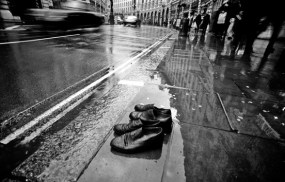 Two-pair-of-old-shoes-try-to-cross-Regent-street-London-on-a-rainy-day