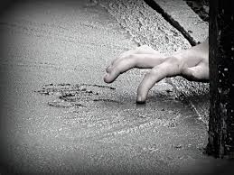 Pamela-Reynolds-photo-of-child-writing-on-wet-cement