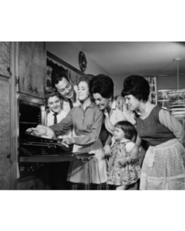 teenage-girl-putting-a-turkey-into-an-oven-with-her-family-standing-beside-her-canvas-art-24-x-36.jpeg